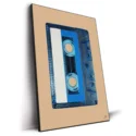 Translucent blue audio cassette tape with a white and blue label against a warm tan background.