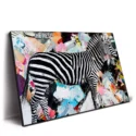A zebra in black and white stripes, surrounded by a colorful abstract background, creating a vibrant artistic composition.