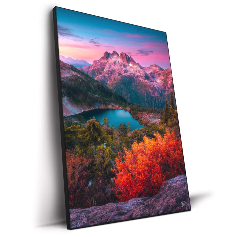 Dusk scene in the North Cascades, featuring rugged peaks, an alpine lake, and vibrant autumn.