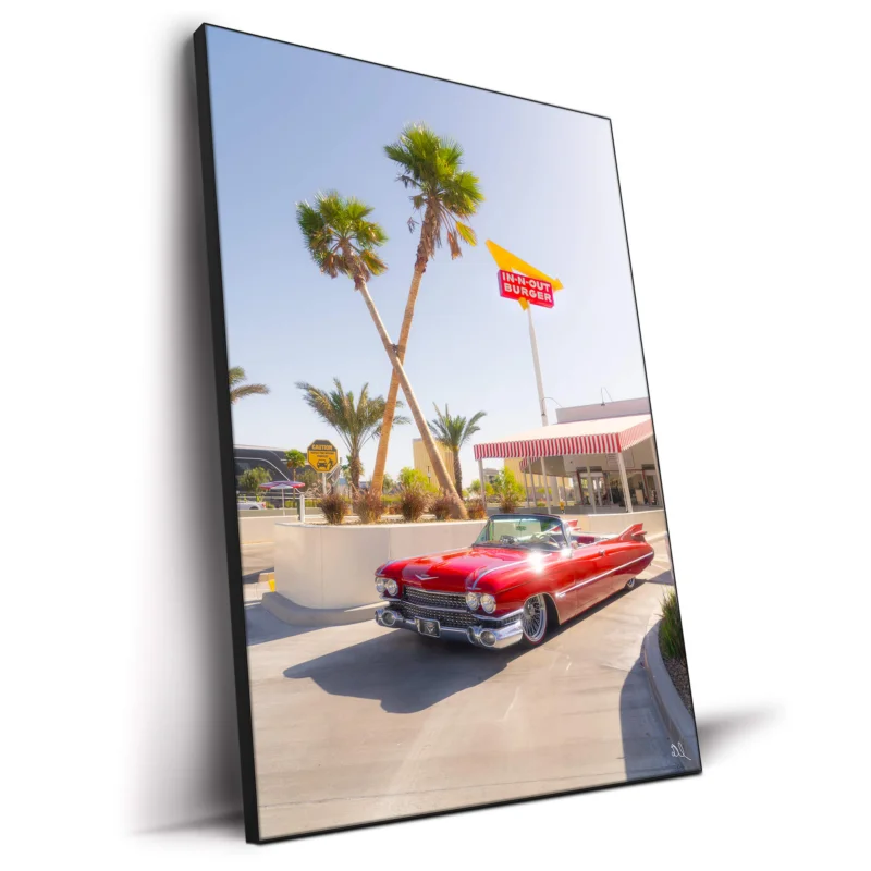 Red convertible parked in front of an In-N-Out Burger with palm trees and a clear blue sky.