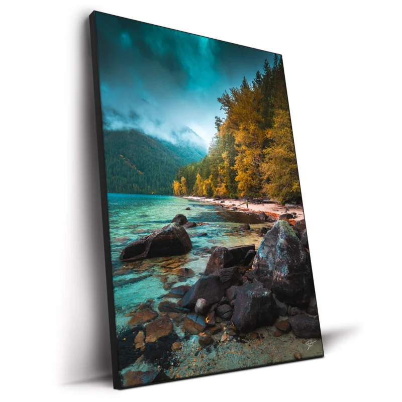 Peaceful mountain lake with clear water and green trees.